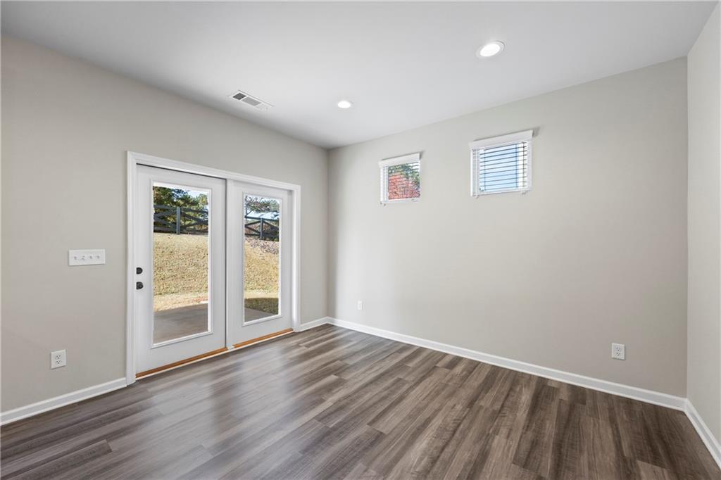30 Fanleaf Drive Fairburn, GA 30213 - Photo 24 of 88 a view of an empty room with wooden floor and windows