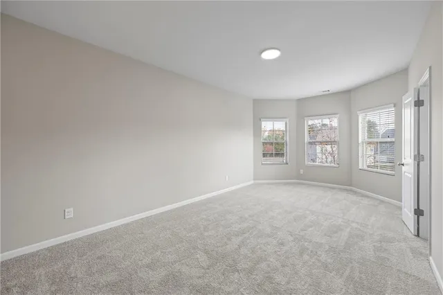 an empty room with a cabinet and mirrors