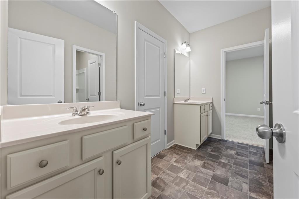 30 Fanleaf Drive Fairburn, GA 30213 - Photo 45 of 88 a bathroom with a double vanity sink a mirror and a bathtub