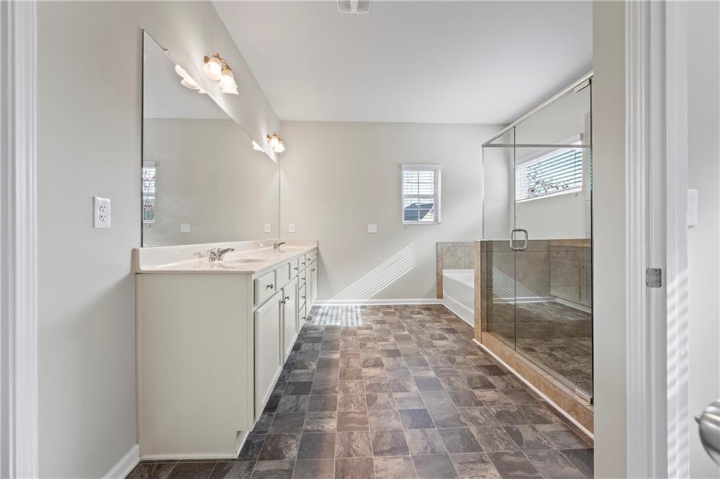 30 Fanleaf Drive Fairburn, GA 30213 - Photo 56 of 88 a bathroom with a sink a mirror and a shower