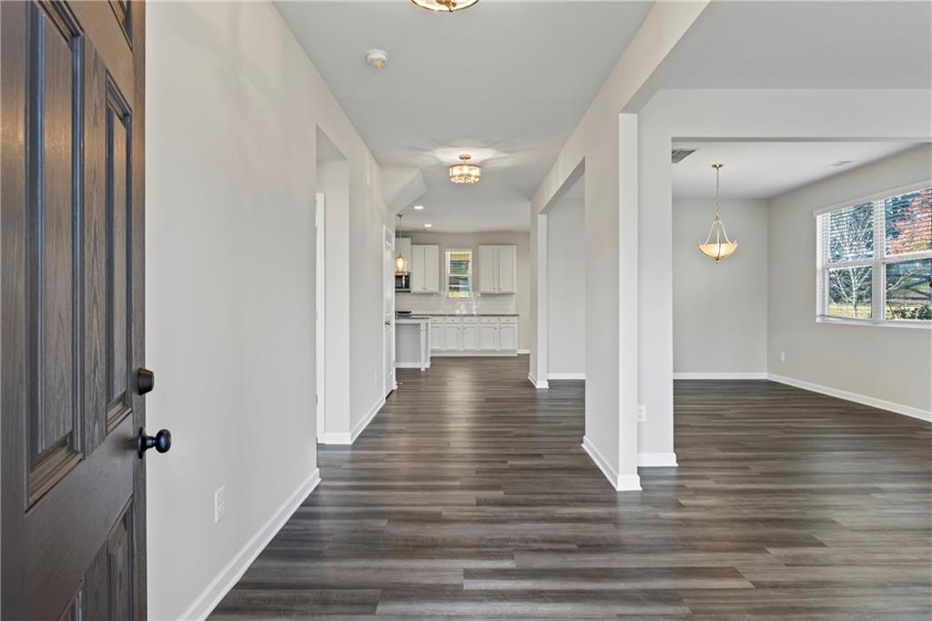 30 Fanleaf Drive Fairburn, GA 30213 - Photo 6 of 88 a view of a hallway with wooden floor and staircase