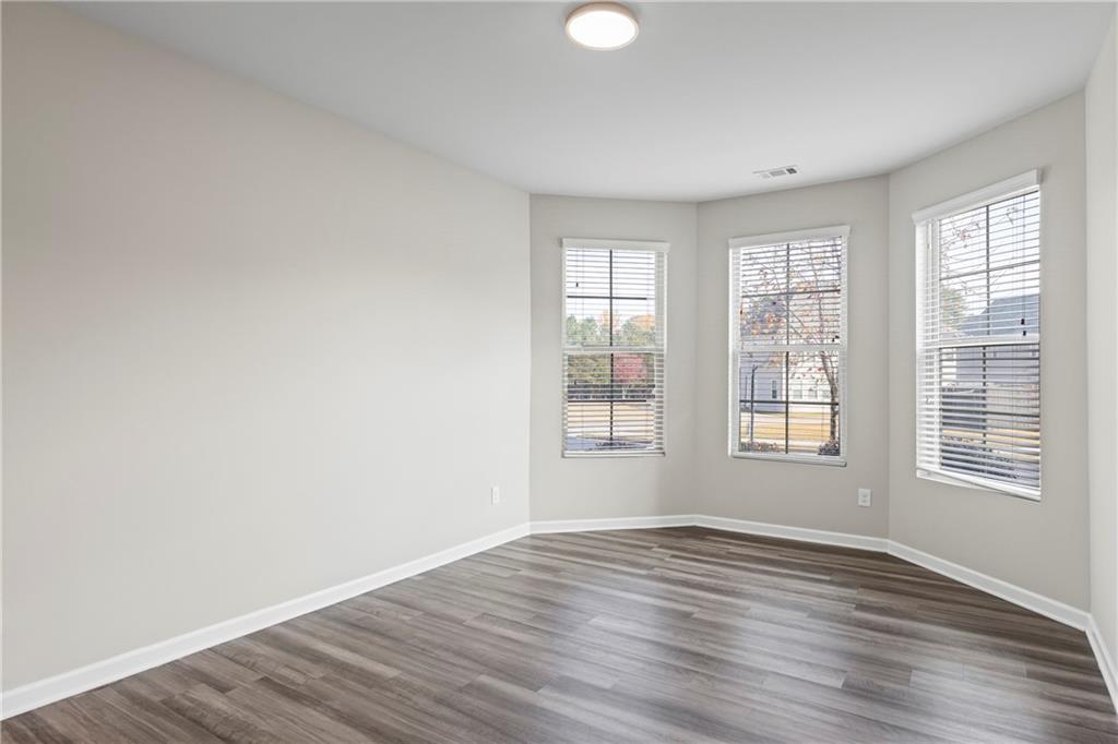 30 Fanleaf Drive Fairburn, GA 30213 - Photo 7 of 88 an empty room with wooden floor and windows