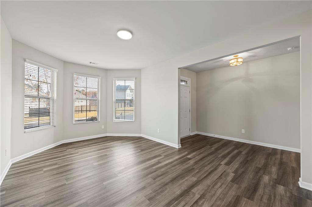 30 Fanleaf Drive Fairburn, GA 30213 - Photo 8 of 88 a view of an empty room with wooden floor and a window