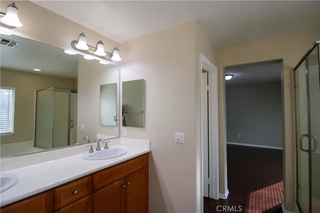 a bathroom with a double vanity sink and a mirror