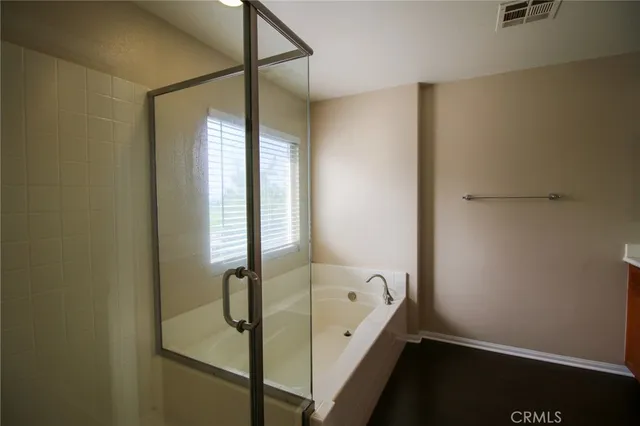a bathroom with a bathtub and shower