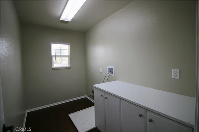 a room with a sink cabinets and utility