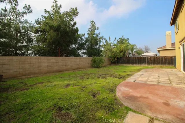 a view of yard with swimming pool and green space