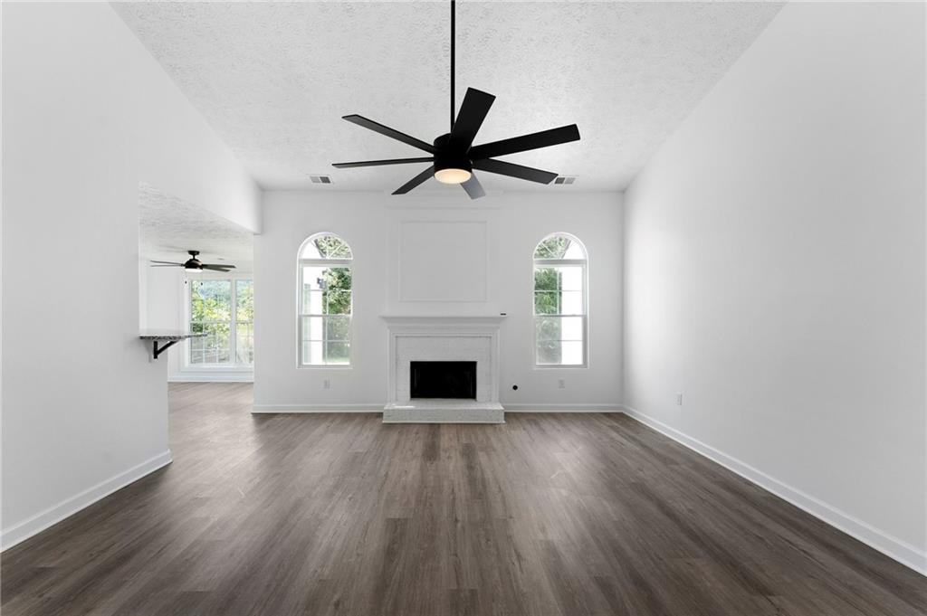 20 Mallet Pointe Street Northeast Cartersville, GA 30121 - Photo 8 of 37 an empty room with windows and a fireplace