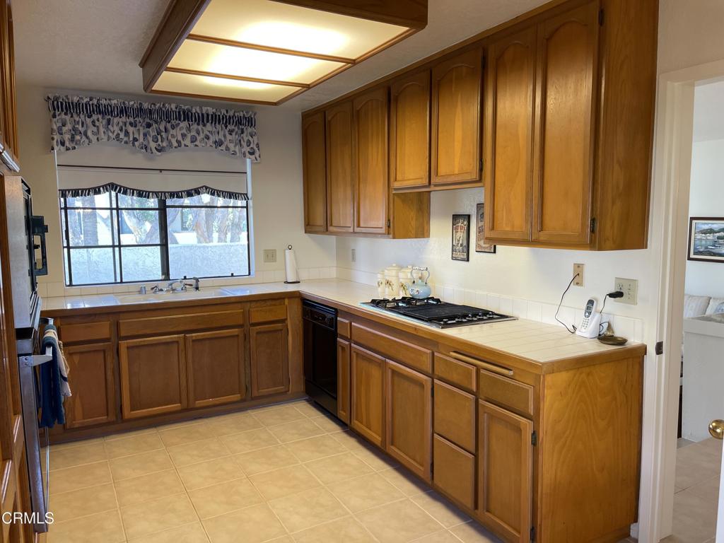 2240 Cannes Square Oxnard, CA 93035 - Photo 23 of 75 a kitchen with stainless steel appliances granite countertop a sink stove and cabinets