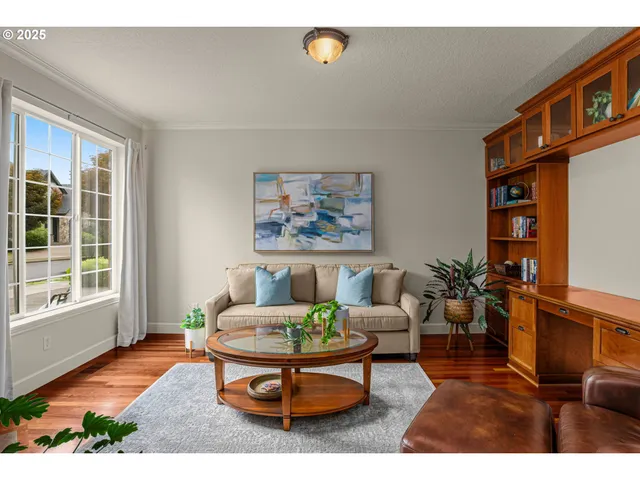 a living room with furniture a rug and a window
