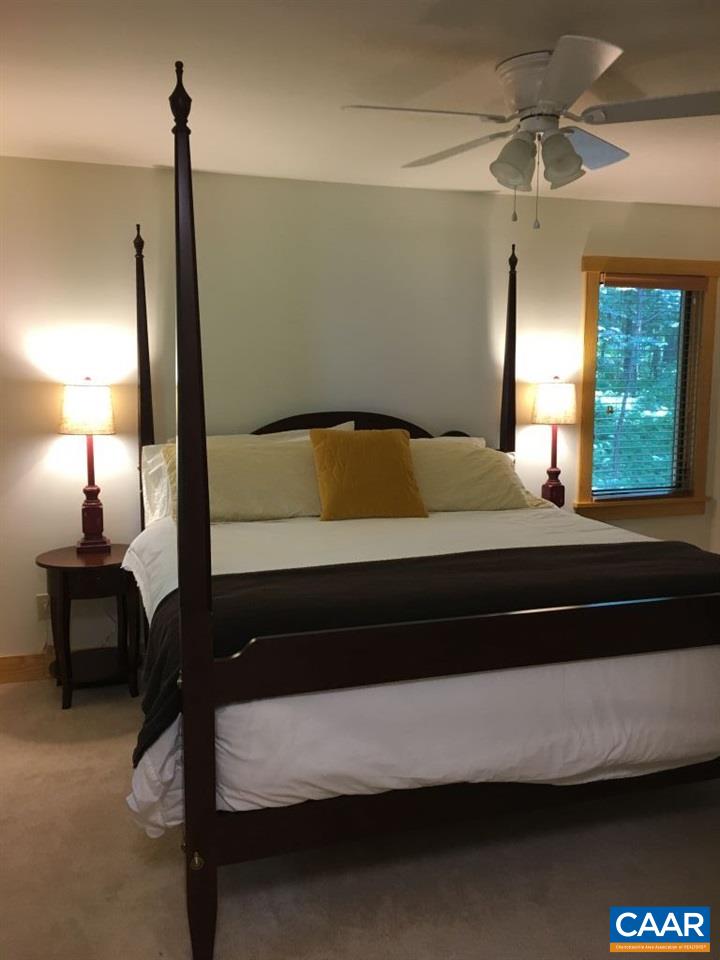 280 Fawn Ridge Drive Roseland, VA 22967 - Photo 11 of 19 a bedroom with a bed and a lamp on table