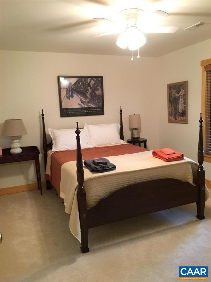 280 Fawn Ridge Drive Roseland, VA 22967 - Photo 16 of 19 a bedroom with a bed and a chandelier