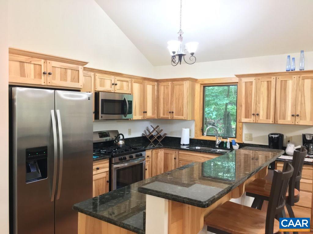 280 Fawn Ridge Drive Roseland, VA 22967 - Photo 5 of 19 a kitchen with granite countertop a refrigerator a sink a stove and chairs