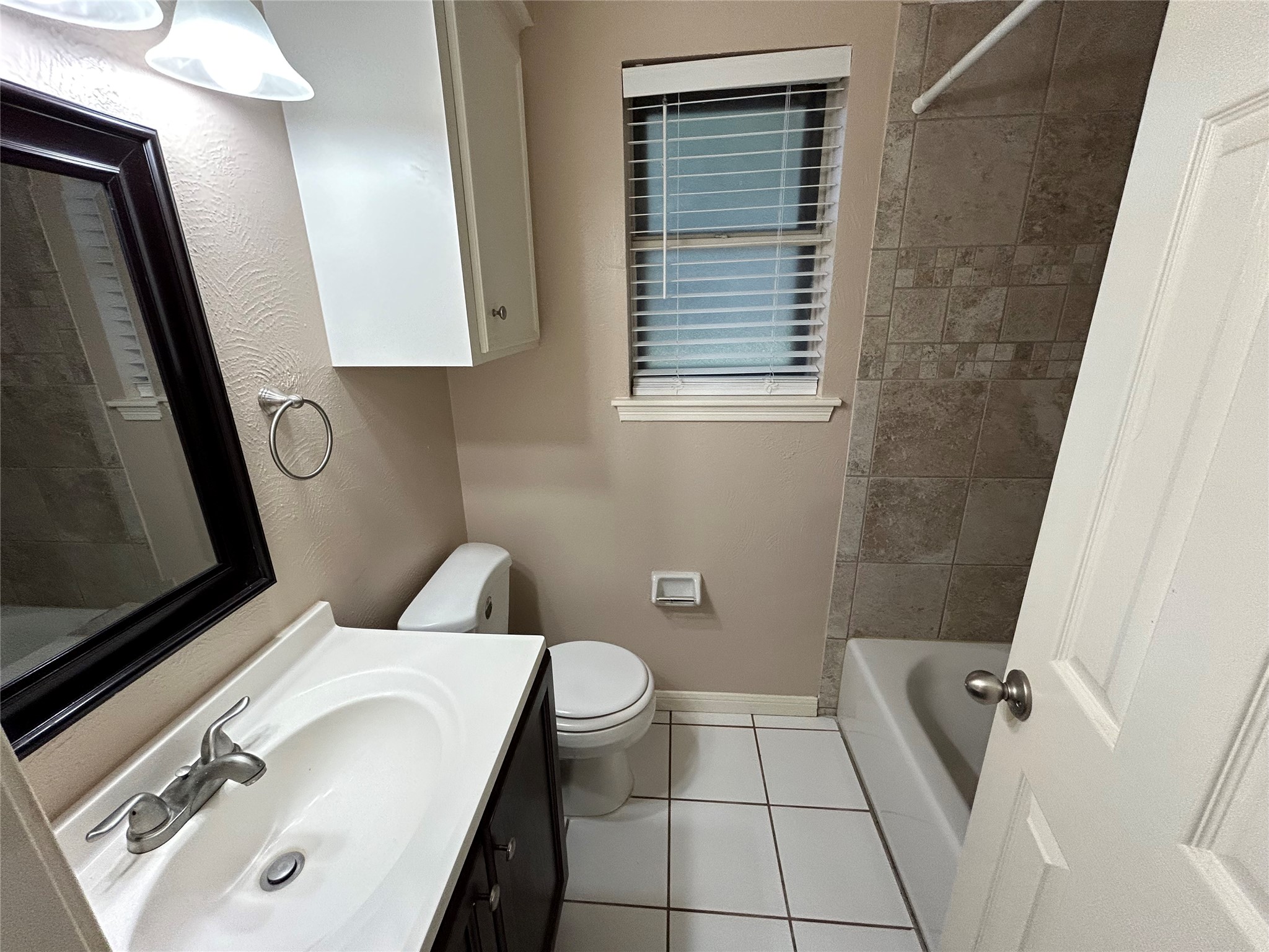 4146 Bermuda Drive Pasadena, TX 77503 - Photo 11 of 16 a bathroom with a sink a toilet and a mirror