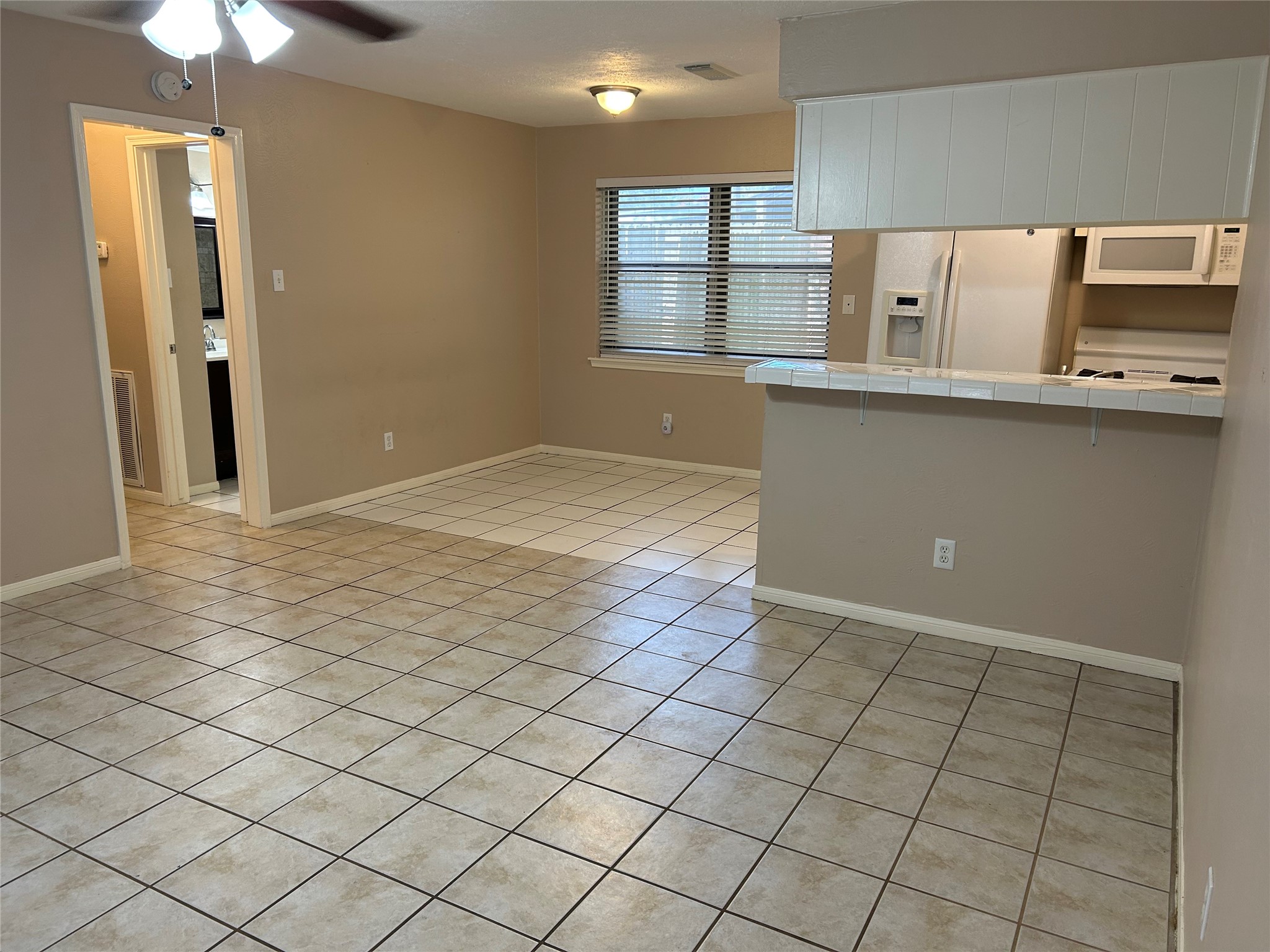 4146 Bermuda Drive Pasadena, TX 77503 - Photo 5 of 16 a view of a kitchen with an empty space and a window