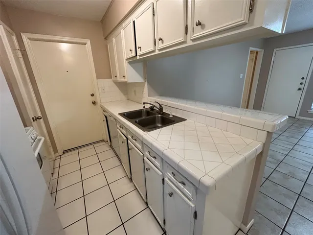 a kitchen with a sink and cabinets