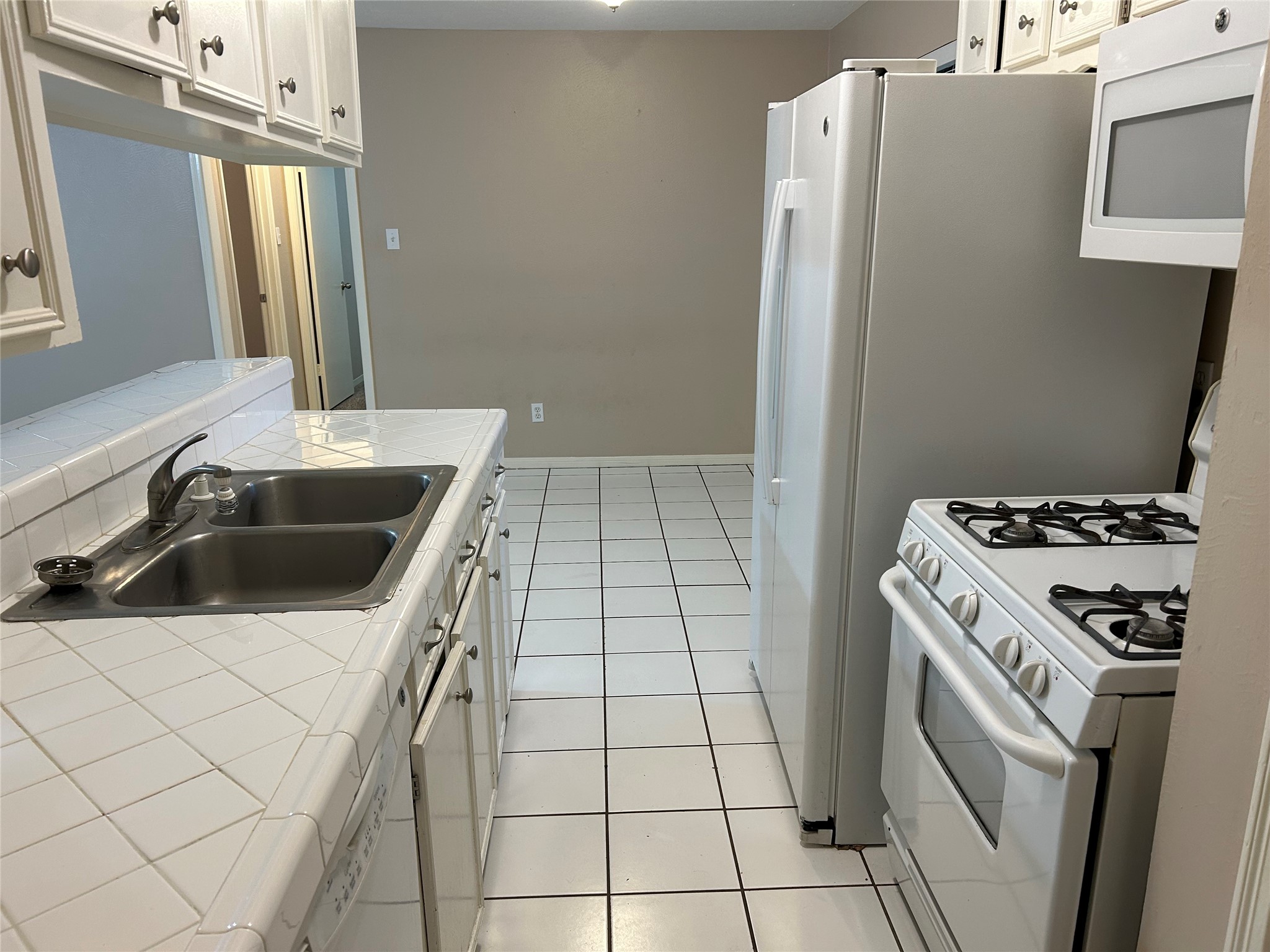 4146 Bermuda Drive Pasadena, TX 77503 - Photo 8 of 16 a kitchen with a sink a stove and refrigerator