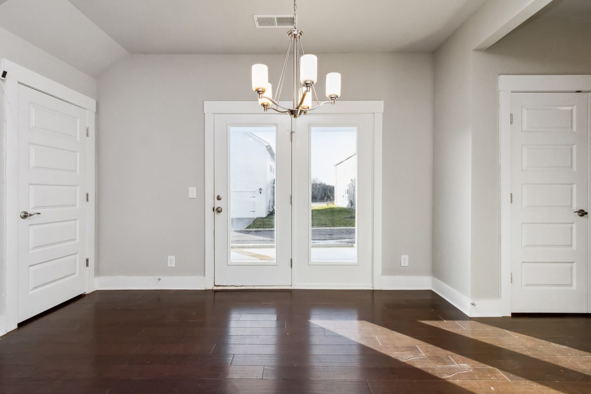3261 Longstalk Road Antioch, TN 37013 - Photo 12 of 46 an empty room with wooden floor chandelier and windows