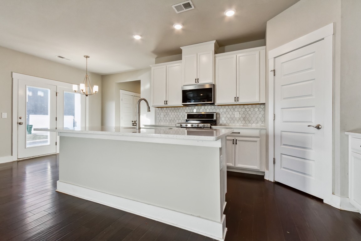 3261 Longstalk Road Antioch, TN 37013 - Photo 5 of 46 a kitchen with white cabinets and stainless steel appliances