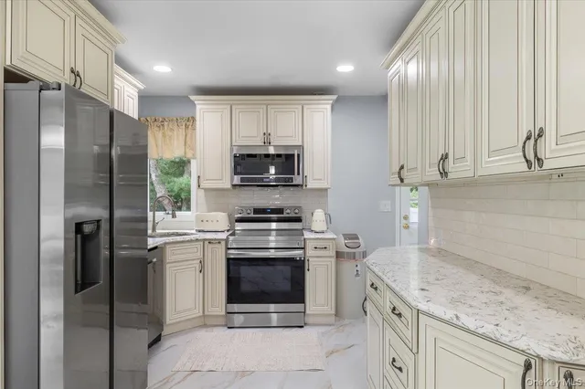 a kitchen with a sink stainless steel appliances and cabinets