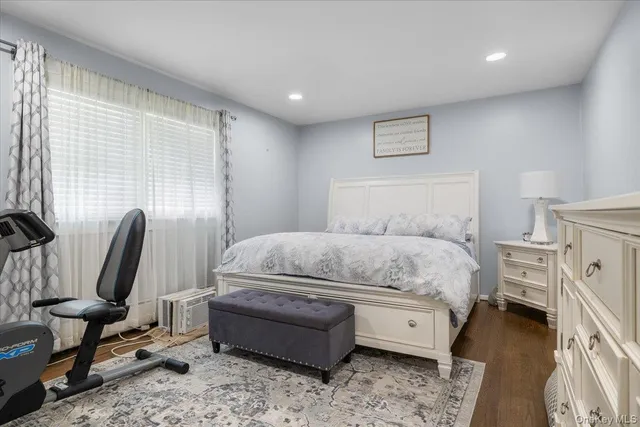 a bedroom with a bed a chair and a couch