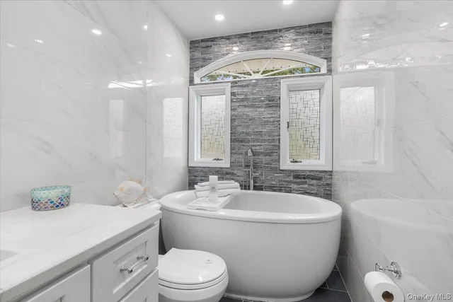 a bathroom with a toilet a sink and a bathtub