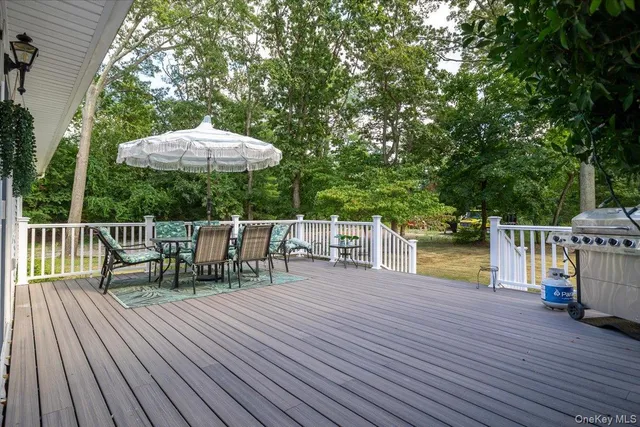 a view of a chairs and table on the wooden deck