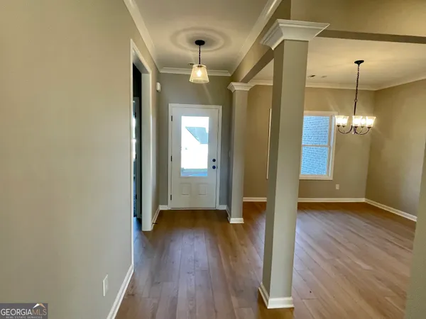 a view of a room with wooden floor and staircase