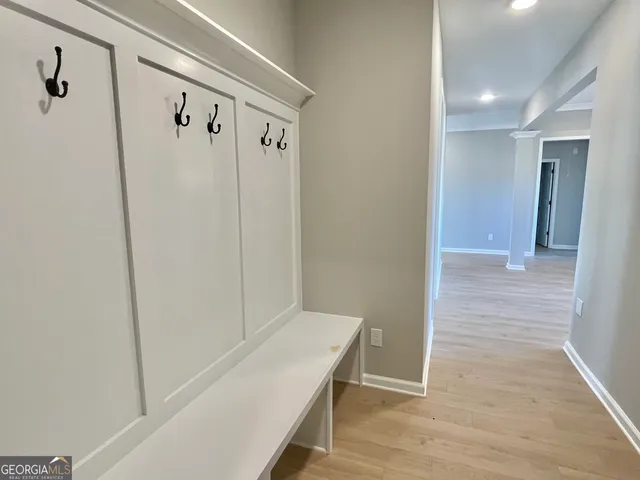 a view of a hallway with wooden floor