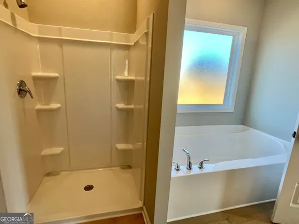 a bathroom with a tub and shower
