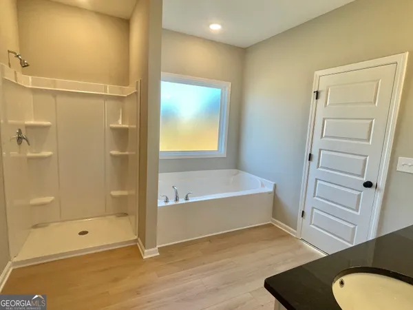 a bathroom with a tub and shower
