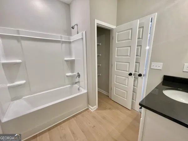 a bathroom with a bathtub and a shower