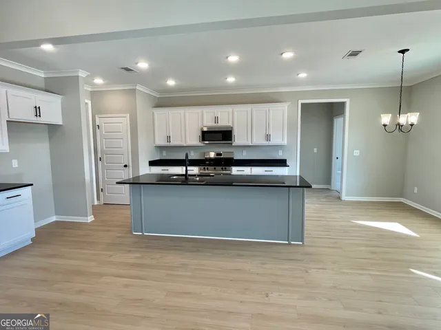 a view of kitchen with kitchen island stainless steel appliances sink and stove