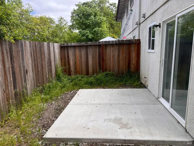 a view of backyard of house with green space