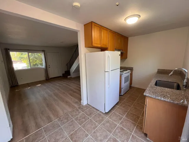 a kitchen with refrigerator and microwave
