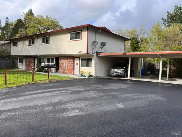 a view of a car park in front of a house