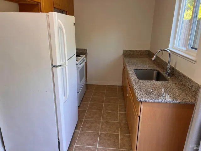 a kitchen with a refrigerator and a sink
