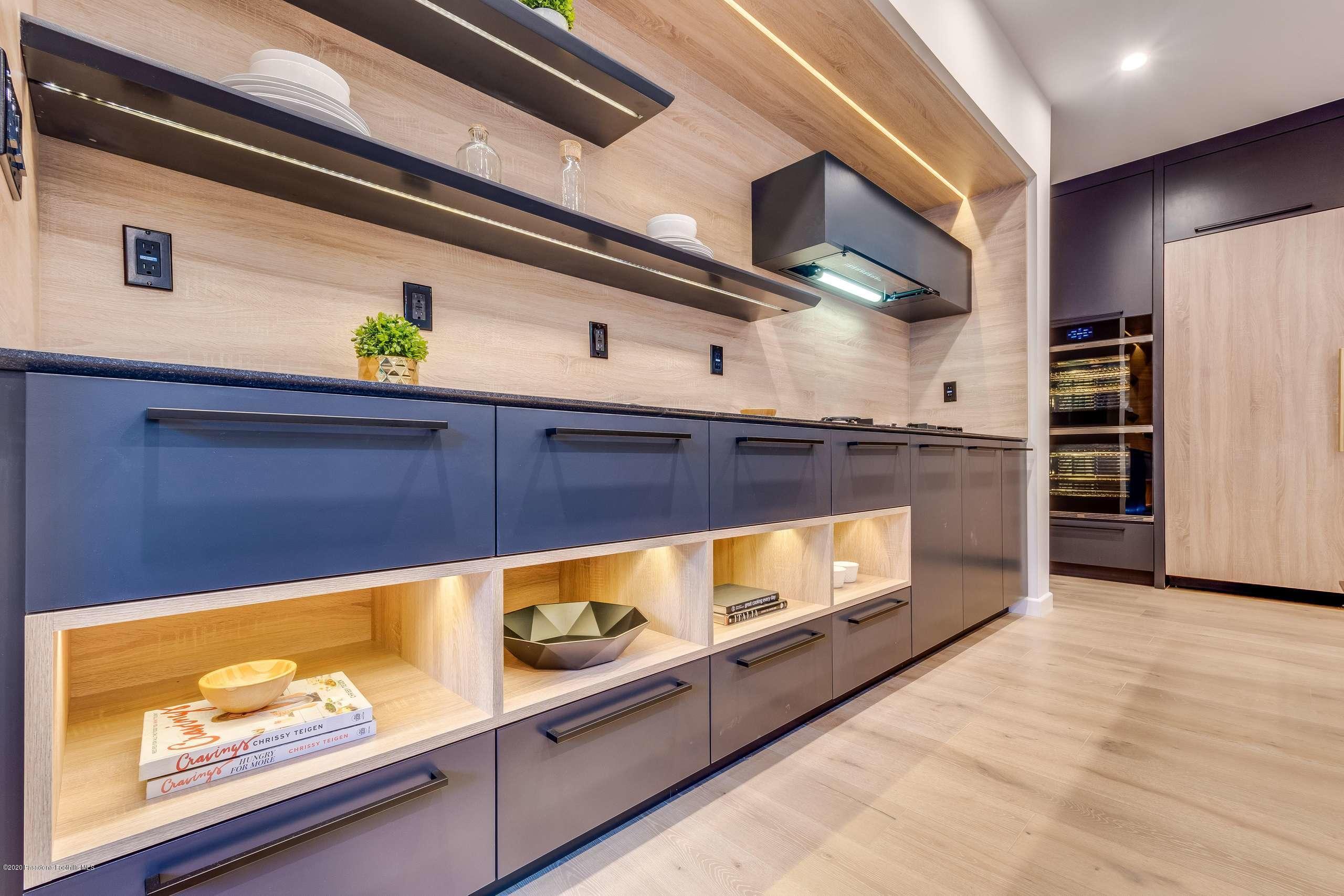 1335 Carnarvon Drive Pasadena, CA 91103 - Photo 18 of 52 a kitchen with stainless steel appliances wooden cabinets and a stove top oven