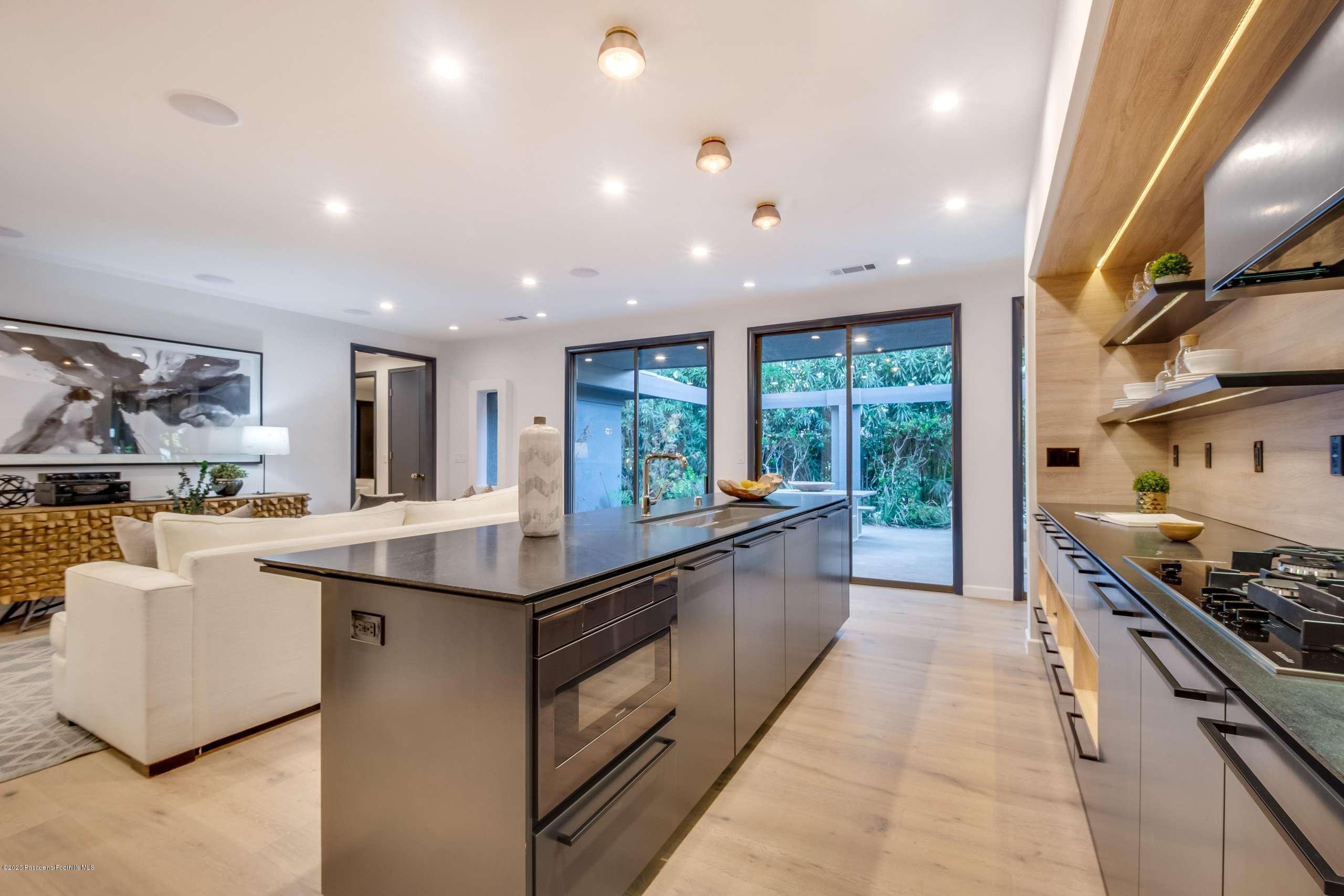 1335 Carnarvon Drive Pasadena, CA 91103 - Photo 22 of 52 a kitchen with stainless steel appliances granite countertop a stove and a sink