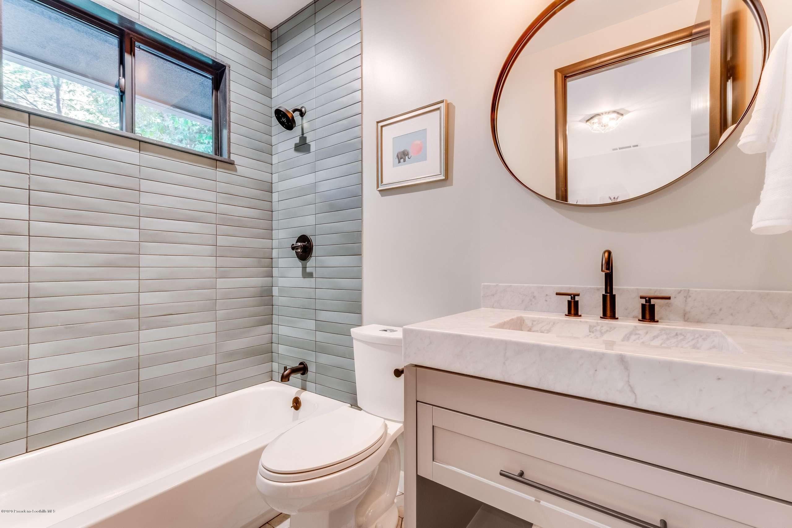 1335 Carnarvon Drive Pasadena, CA 91103 - Photo 35 of 52 a bathroom with a sink a toilet and a mirror