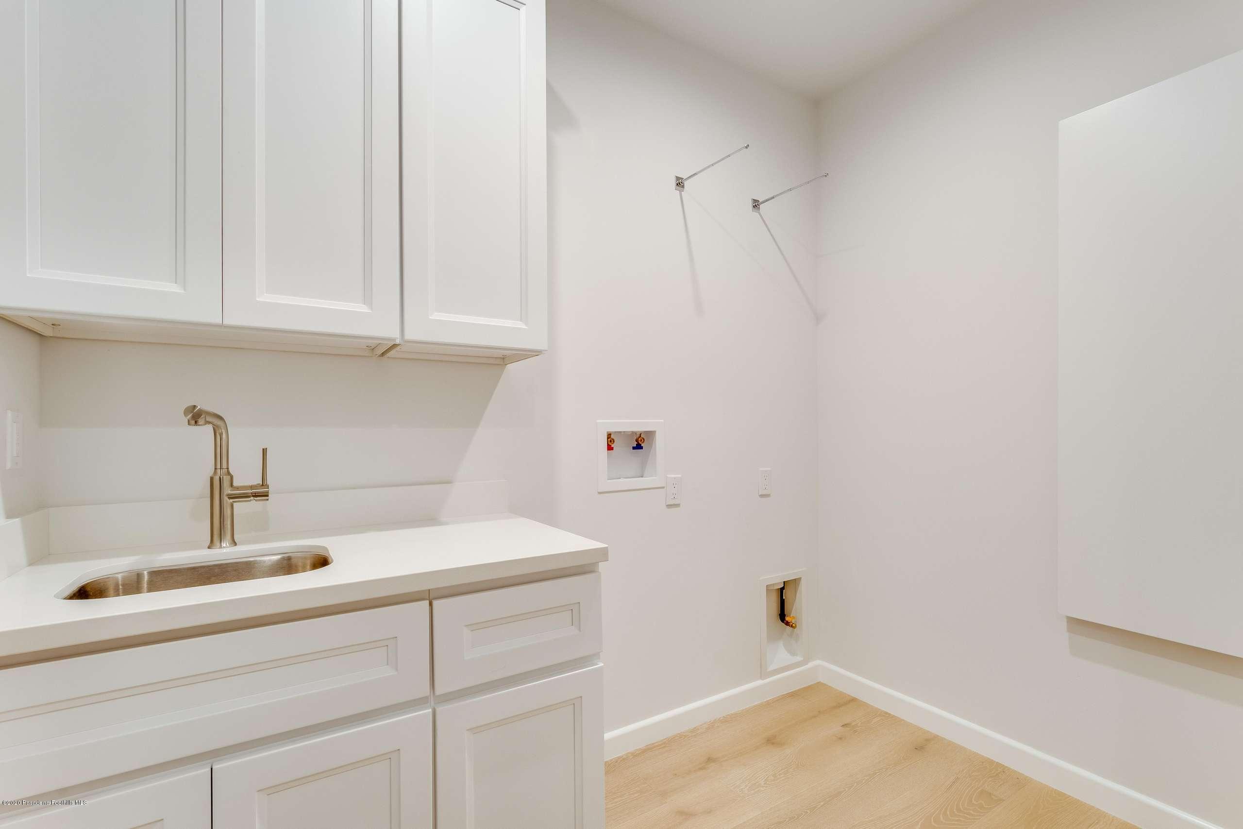 1335 Carnarvon Drive Pasadena, CA 91103 - Photo 43 of 52 a bathroom with a sink and cabinets