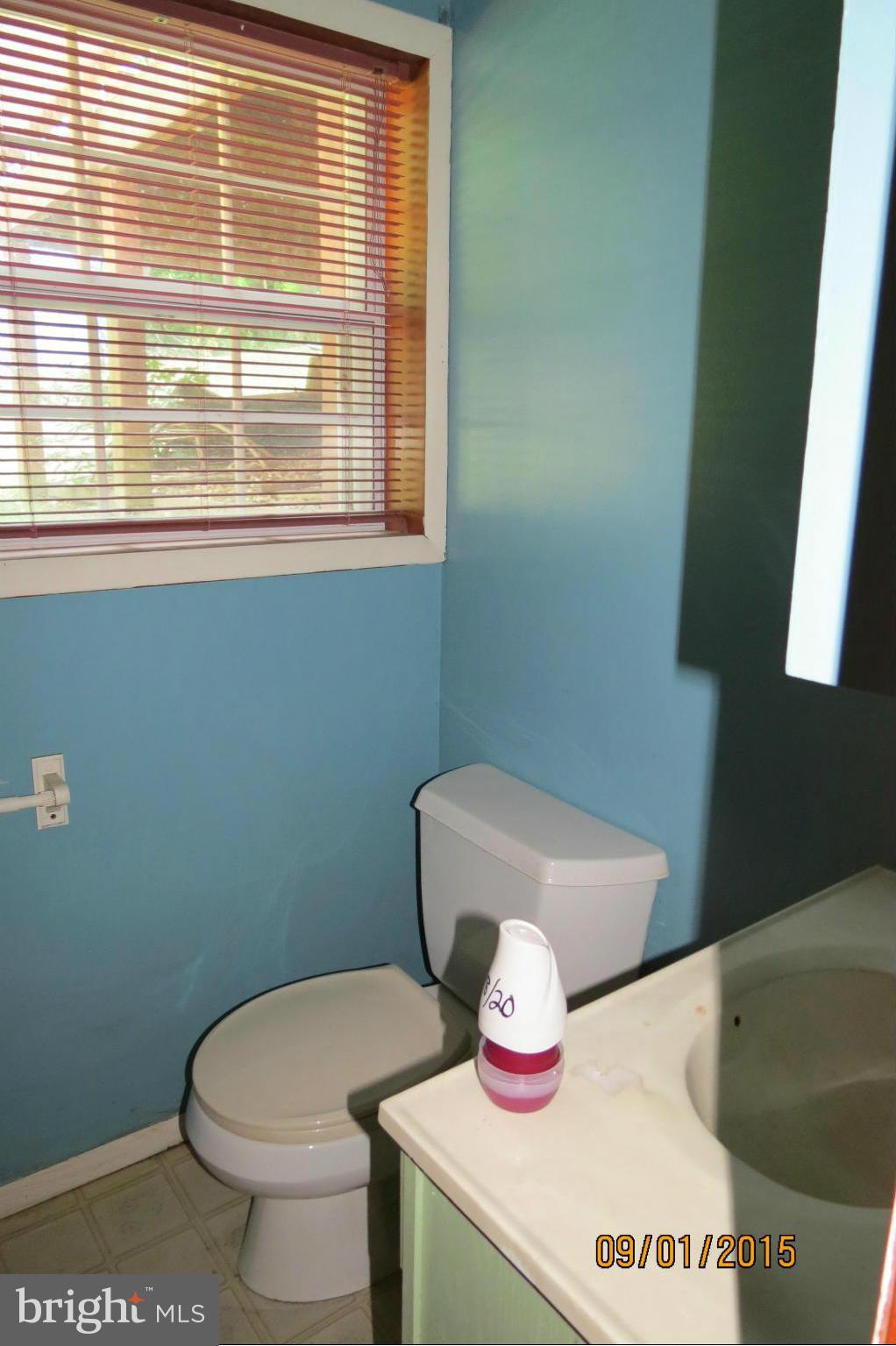 6056 Locust Road St. Leonard, MD 20685 - Photo 6 of 10 a bathroom with a toilet and a sink