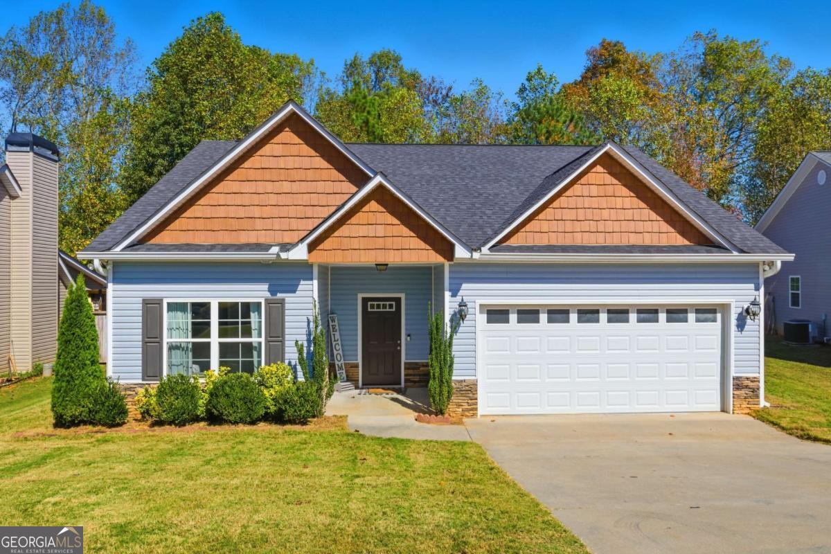 a front view of a house with a yard and garage