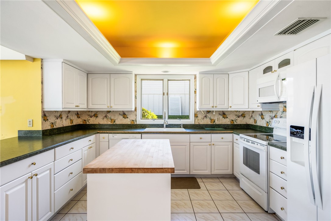18 Tarpon Drive Vero Beach, FL 32960 - Photo 18 of 36 a kitchen with a white cabinets and white appliances