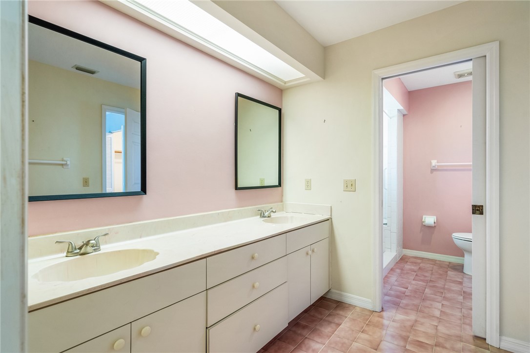 18 Tarpon Drive Vero Beach, FL 32960 - Photo 23 of 36 a bathroom with a double vanity sink and mirror with toilet