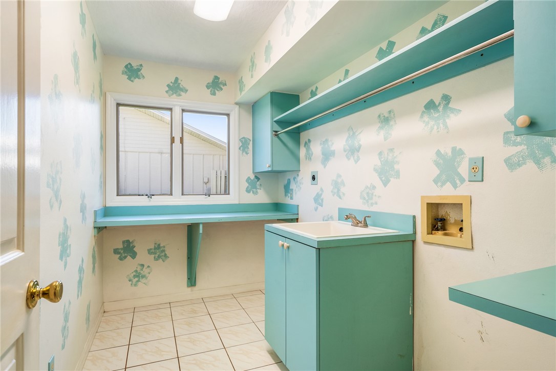 18 Tarpon Drive Vero Beach, FL 32960 - Photo 26 of 36 a kitchen with a sink and a refrigerator