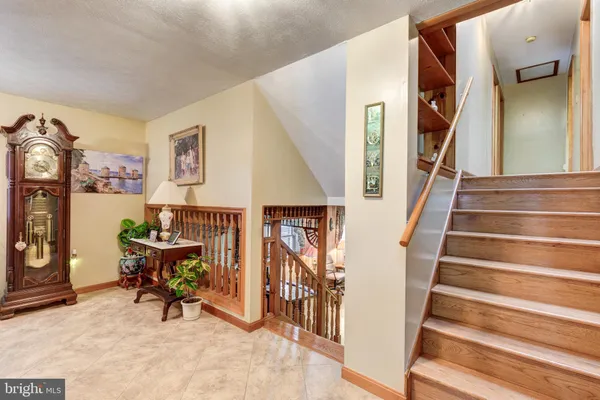 a view of entryway with furniture and stairs