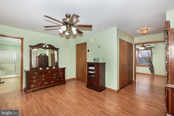 a view of workspace with wooden floor and ceiling fan