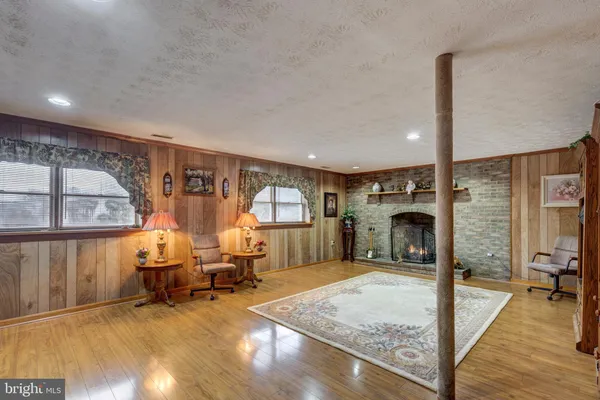 a room with stainless steel appliances kitchen island granite countertop furniture and a large window