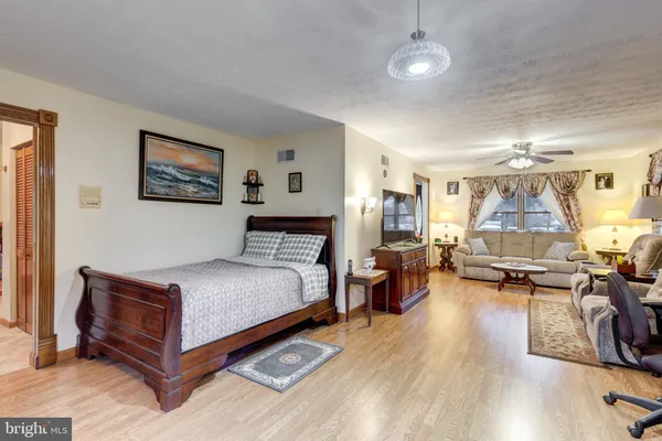 a spacious bedroom with a bed and a table in it